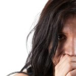 A woman covers her mouth with her hands