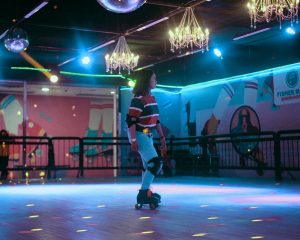 a man riding a skateboard on top of a dance floor